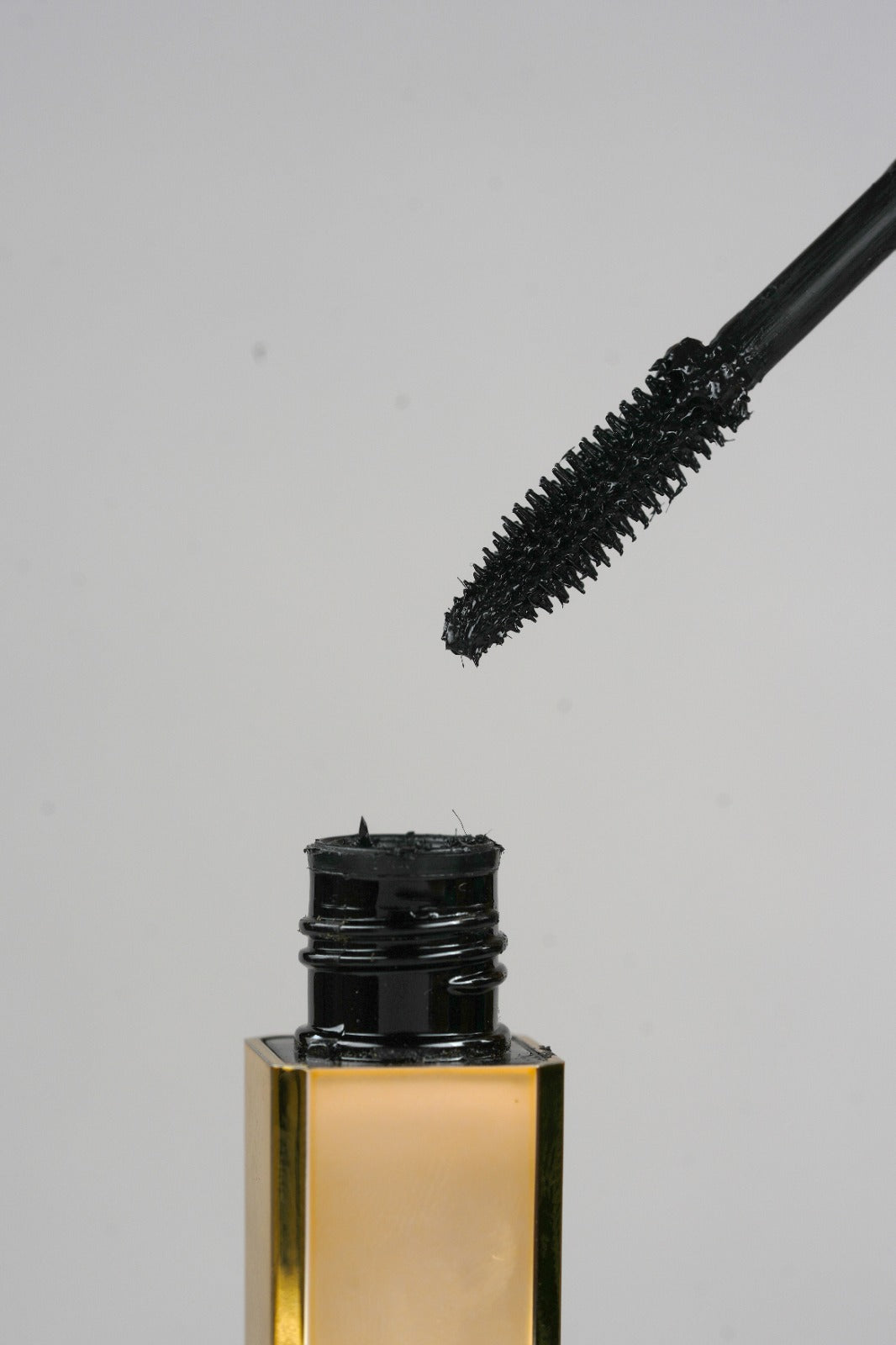 Black mascara before-and-after comparison showing lash volume